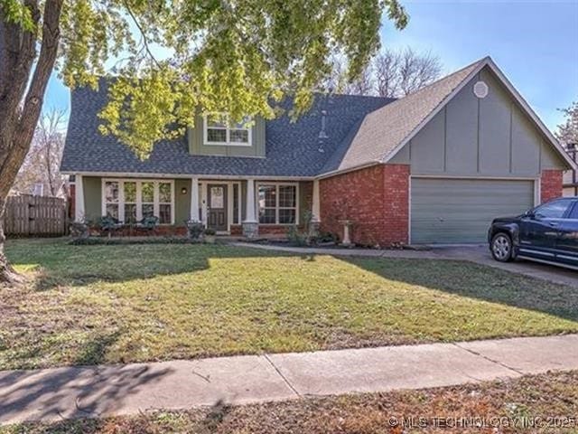 view of front of house with a front yard and a garage