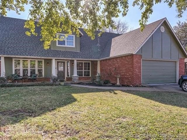 view of front of home with a front yard and a garage