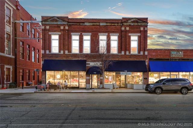 view of outdoor building at dusk