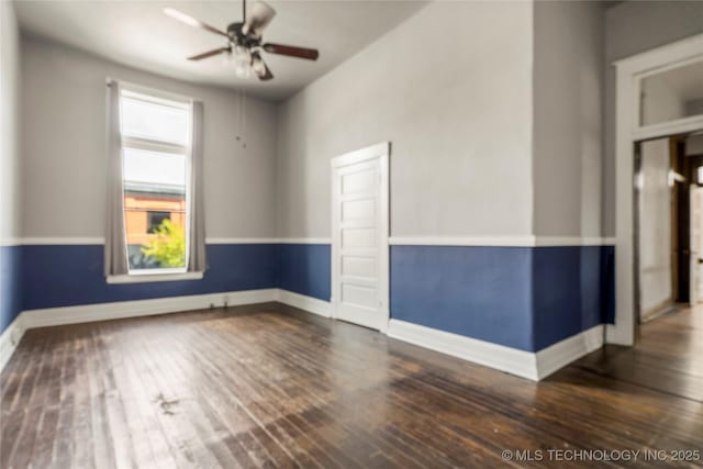 unfurnished room featuring ceiling fan and dark wood-type flooring