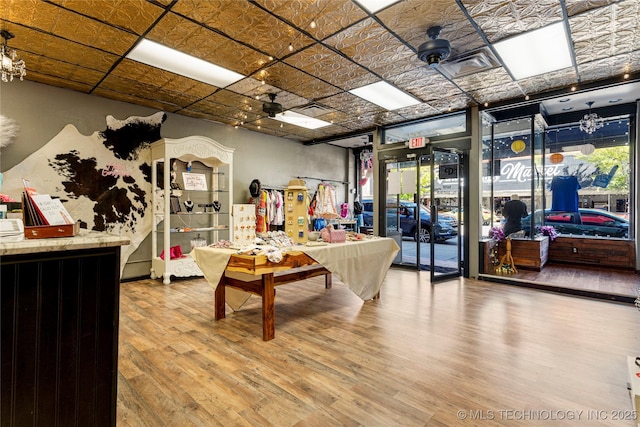 playroom with ceiling fan, hardwood / wood-style floors, and a wealth of natural light