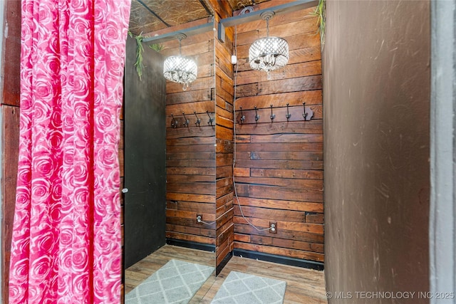 bathroom featuring wood walls and hardwood / wood-style flooring