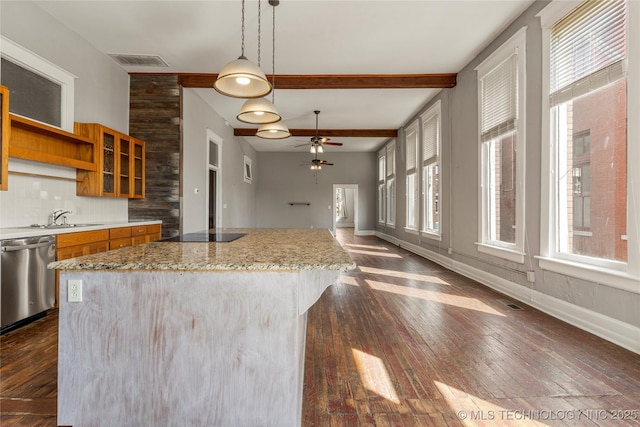 kitchen with decorative light fixtures, beamed ceiling, tasteful backsplash, stainless steel dishwasher, and a healthy amount of sunlight