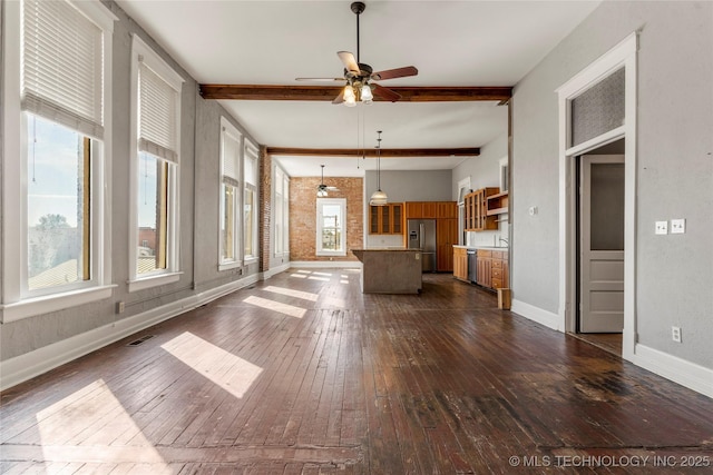 unfurnished living room featuring dark wood-type flooring, ceiling fan, and beam ceiling