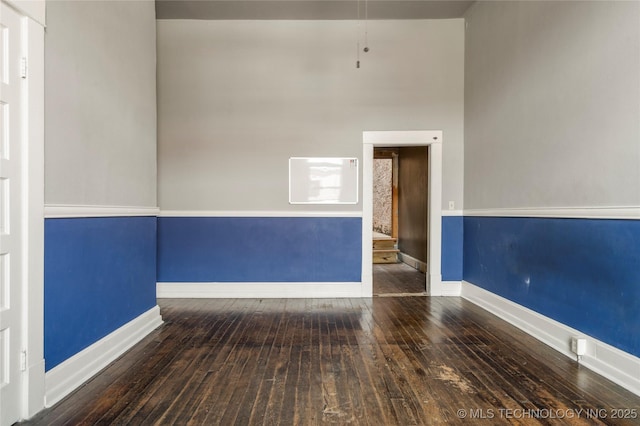 empty room with dark hardwood / wood-style floors