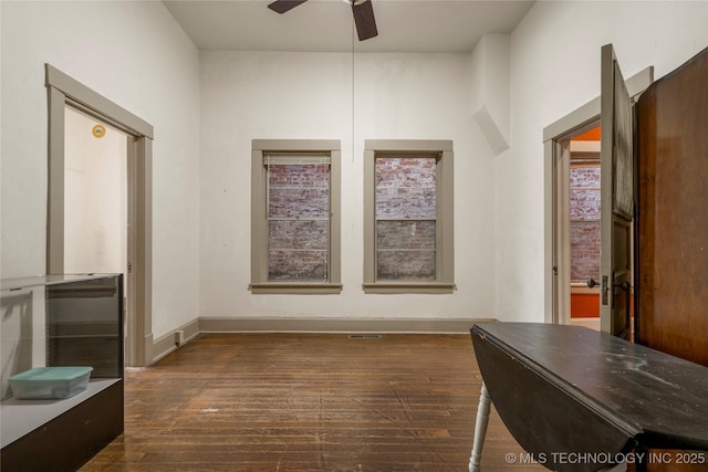 interior space with ceiling fan and dark hardwood / wood-style flooring