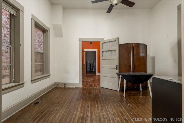 empty room featuring ceiling fan and dark hardwood / wood-style floors