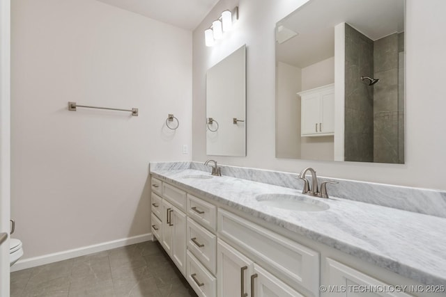 5809 E 126th Pl S, Tulsa, OK 74008 - full bath featuring double vanity, baseboards, toilet, and tile patterned floors