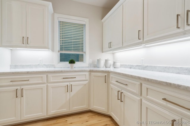 5809 E 126th Pl S, Tulsa, OK 74008 - kitchen featuring light stone counters, light wood-style flooring, and white cabinetry
