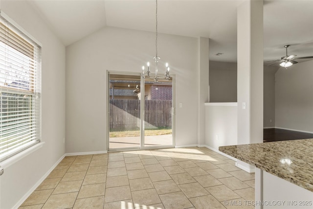 unfurnished dining area with lofted ceiling, light tile patterned floors, ceiling fan with notable chandelier, and a wealth of natural light