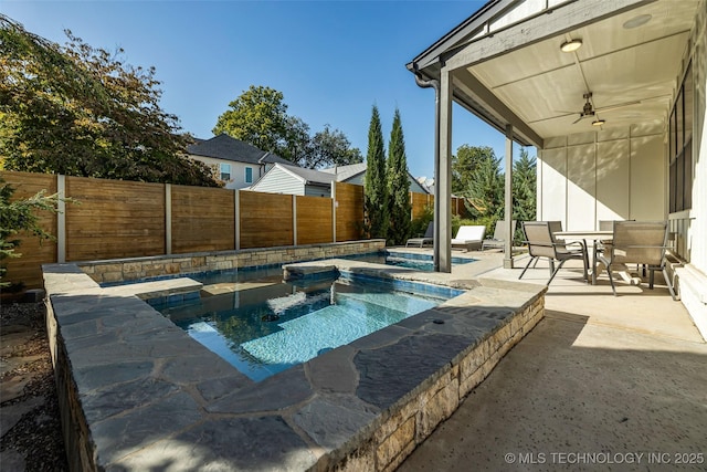 view of pool featuring a patio, ceiling fan, and an in ground hot tub