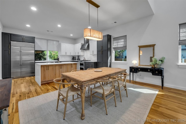 dining area with sink and light hardwood / wood-style flooring