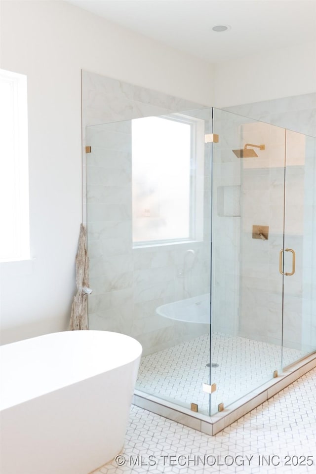 bathroom featuring tile patterned floors and shower with separate bathtub