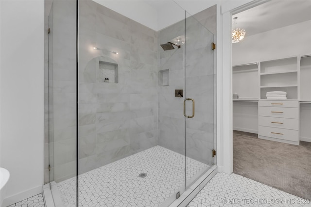 bathroom featuring a notable chandelier and walk in shower