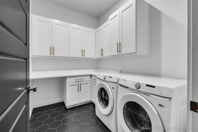 washroom with independent washer and dryer, cabinets, and dark tile patterned floors