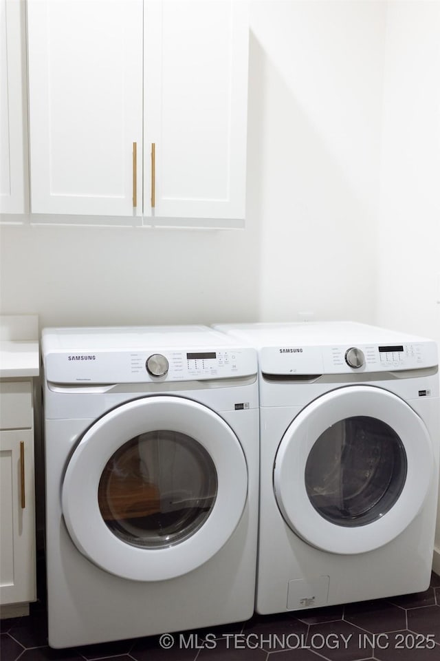 laundry area featuring cabinets and washer and clothes dryer