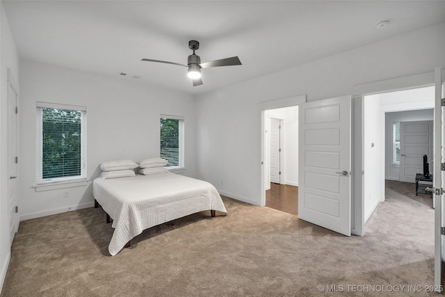 carpeted bedroom with ceiling fan