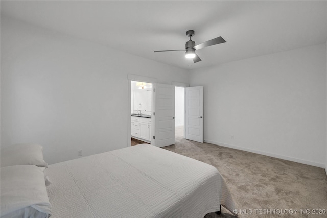 bedroom with ensuite bath, light colored carpet, ceiling fan, and sink