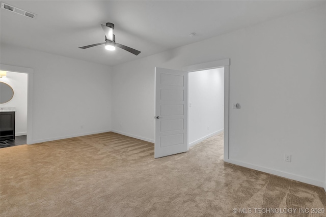 carpeted empty room featuring ceiling fan