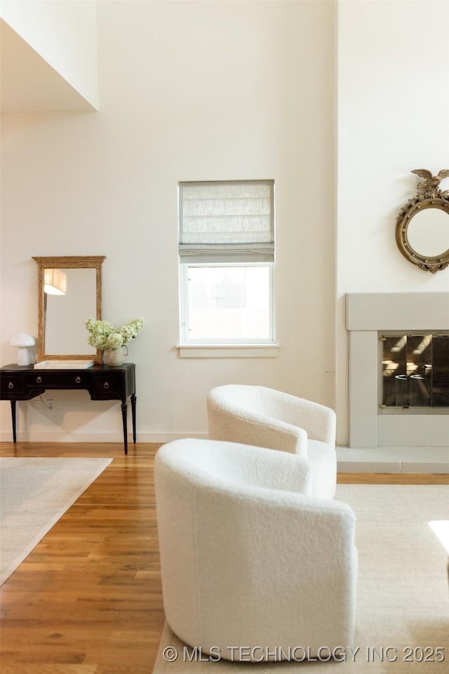 sitting room with hardwood / wood-style flooring