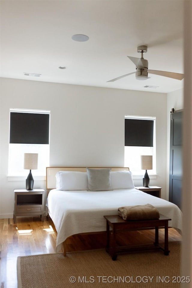 bedroom featuring wood-type flooring and ceiling fan