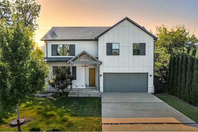 modern inspired farmhouse featuring a lawn and a garage