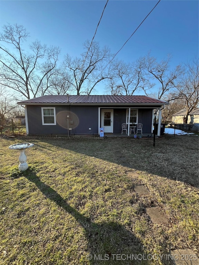 rear view of property with a lawn and a porch