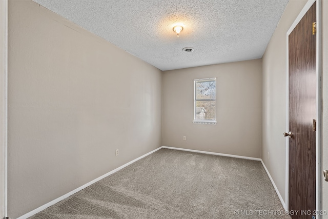 unfurnished room featuring carpet floors and a textured ceiling