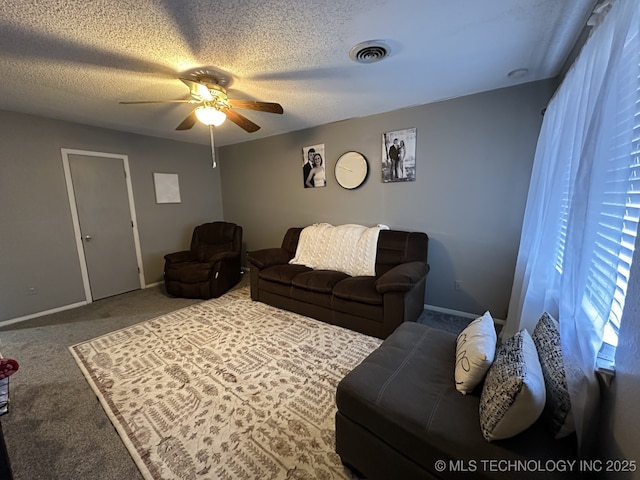 living room featuring carpet flooring, a textured ceiling, and ceiling fan