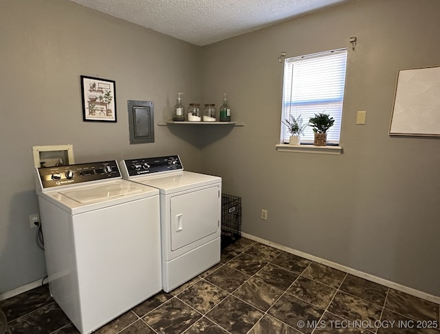 laundry room with a textured ceiling and washing machine and clothes dryer