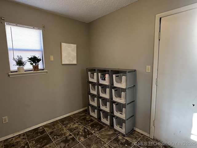 laundry room featuring a textured ceiling