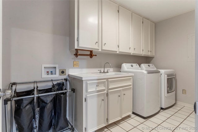 washroom with sink, washing machine and dryer, light tile patterned flooring, and cabinets