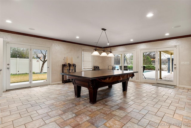 recreation room with crown molding and plenty of natural light