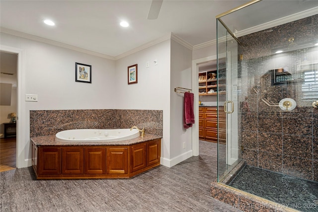 bathroom featuring ornamental molding, hardwood / wood-style floors, and independent shower and bath