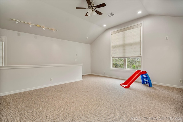 game room featuring ceiling fan, vaulted ceiling, carpet flooring, and rail lighting