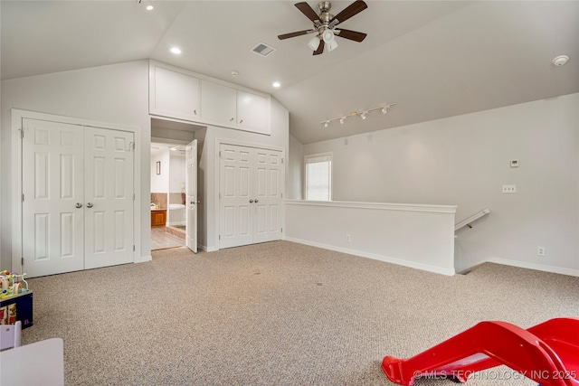 interior space featuring lofted ceiling, rail lighting, and ceiling fan