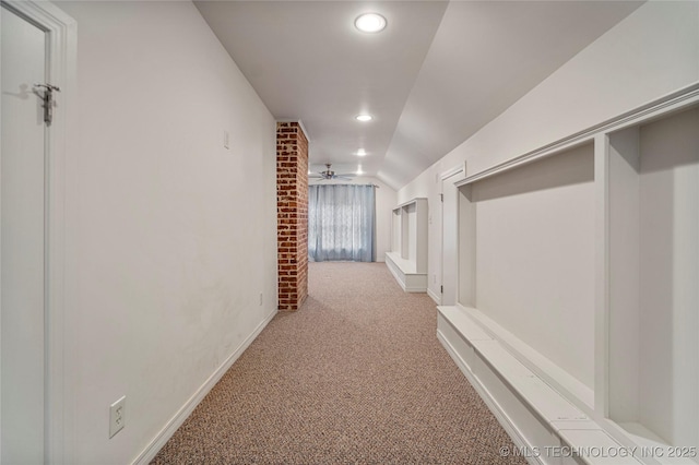 hall featuring light carpet and vaulted ceiling