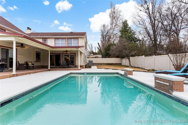 view of swimming pool featuring a patio and ceiling fan