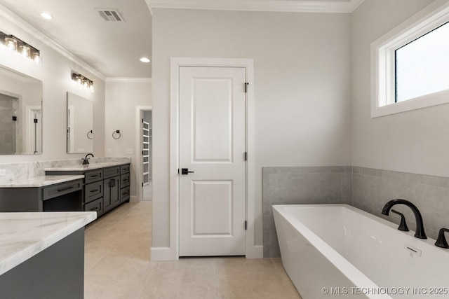 223 W 172nd St S, Mounds, OK 74047 - full bathroom with tile patterned floors, a soaking tub, vanity, ornamental molding, and recessed lighting