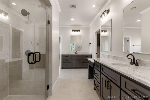 223 W 172nd St S, Mounds, OK 74047 - bathroom featuring two vanities, a shower stall, crown molding, tile patterned floors, and recessed lighting
