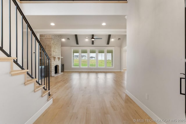 223 W 172nd St S, Mounds, OK 74047 - unfurnished living room with ceiling fan, light wood-style flooring, stairs, and a fireplace