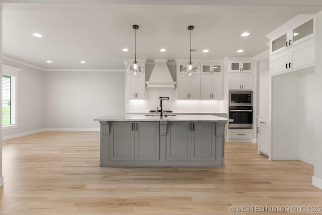 223 W 172nd St S, Mounds, OK 74047 - kitchen with appliances with stainless steel finishes, premium range hood, ornamental molding, white cabinetry, and light wood-style flooring
