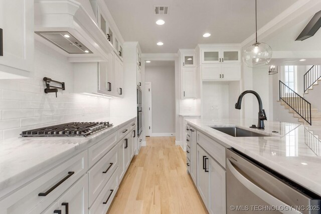 223 W 172nd St S, Mounds, OK 74047 - kitchen with stainless steel appliances, white cabinets, light stone countertops, backsplash, and recessed lighting