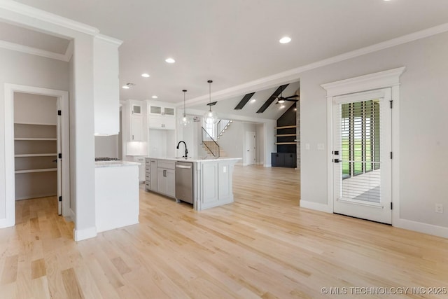 223 W 172nd St S, Mounds, OK 74047 - kitchen featuring stainless steel dishwasher, light countertops, white cabinetry, open floor plan, and light wood finished floors