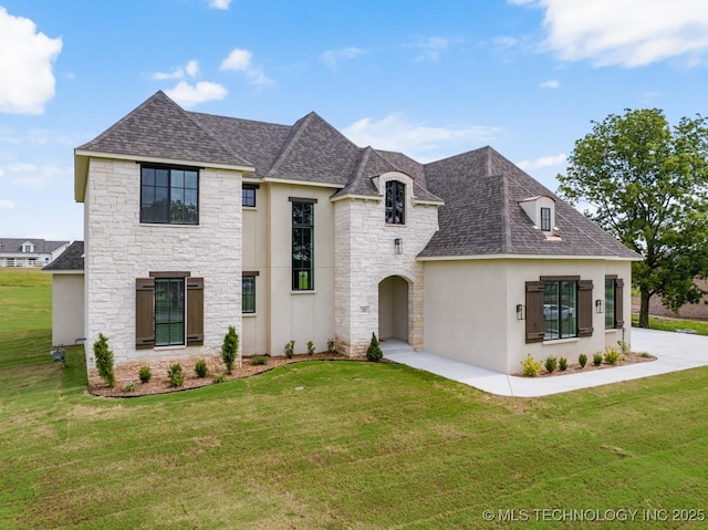 223 W 172nd St S, Mounds, OK 74047 - french country style house with stone siding, roof with shingles, a front lawn, and stucco siding