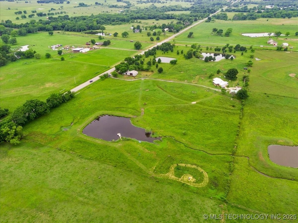 drone / aerial view featuring a water view and a rural view