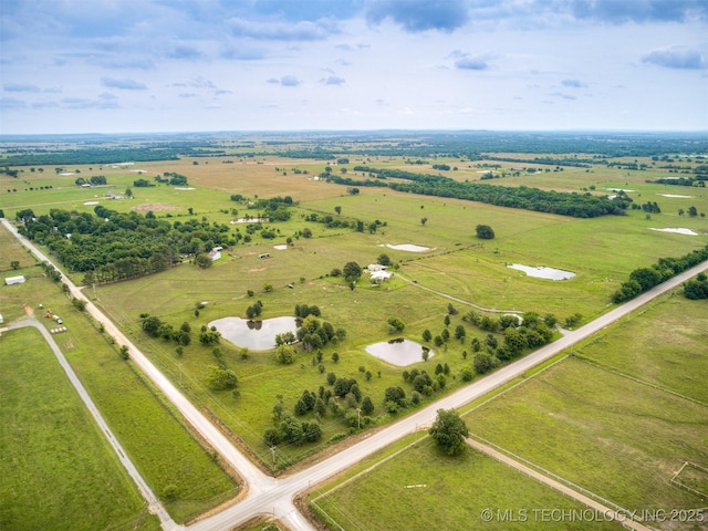 birds eye view of property with a rural view