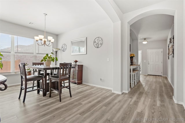 dining room featuring a chandelier and light wood-type flooring