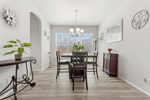 dining room featuring a chandelier and light hardwood / wood-style floors