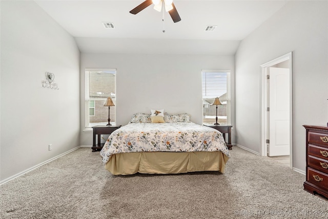 bedroom featuring ceiling fan, light colored carpet, and vaulted ceiling